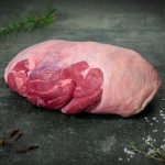 Lammkeule ohne Knochen aus Neuseeland auf Holzbrett serviert