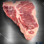 Rohes Michalski Porterhouse Steak vom deutschen Rind mit T-Knochen auf edlem Hintergrund